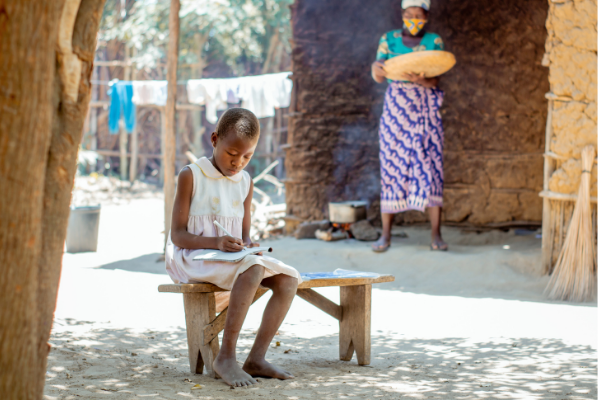 Camila, from Mozambique busy studying. She attends Life Child Peace school in Mozambique