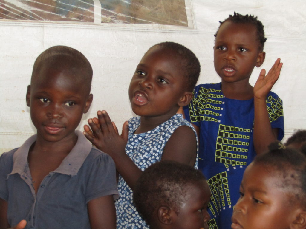 Glory, (middle) at a gift presenting ceremony. She attends Life Child Moyo preschool in Malawi. 