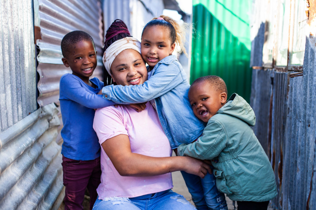 Ladonna, her two children and her little brother hugging 