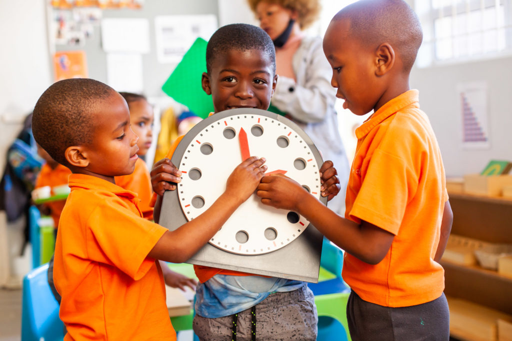 Ndinawe holding a big play clock with his friends 