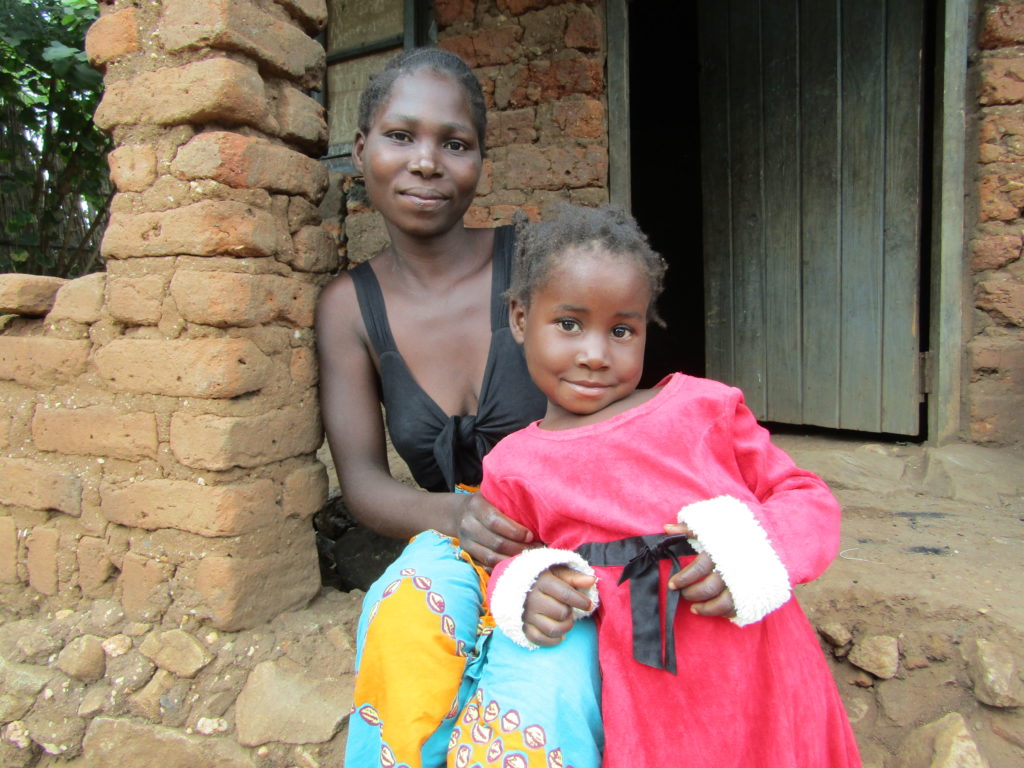 Mercy and her mum at their home