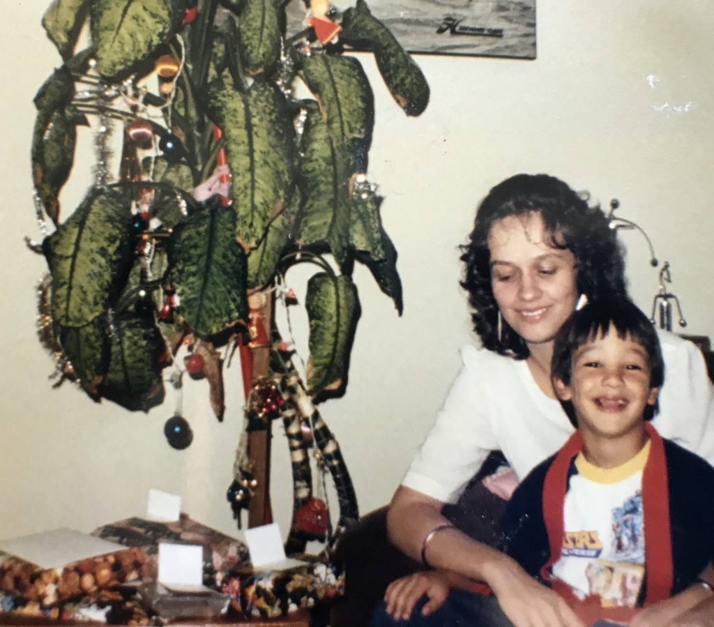 Christmas 1984. Desiree Liebenberg and foster son Robert next to a Christmas tree. 
