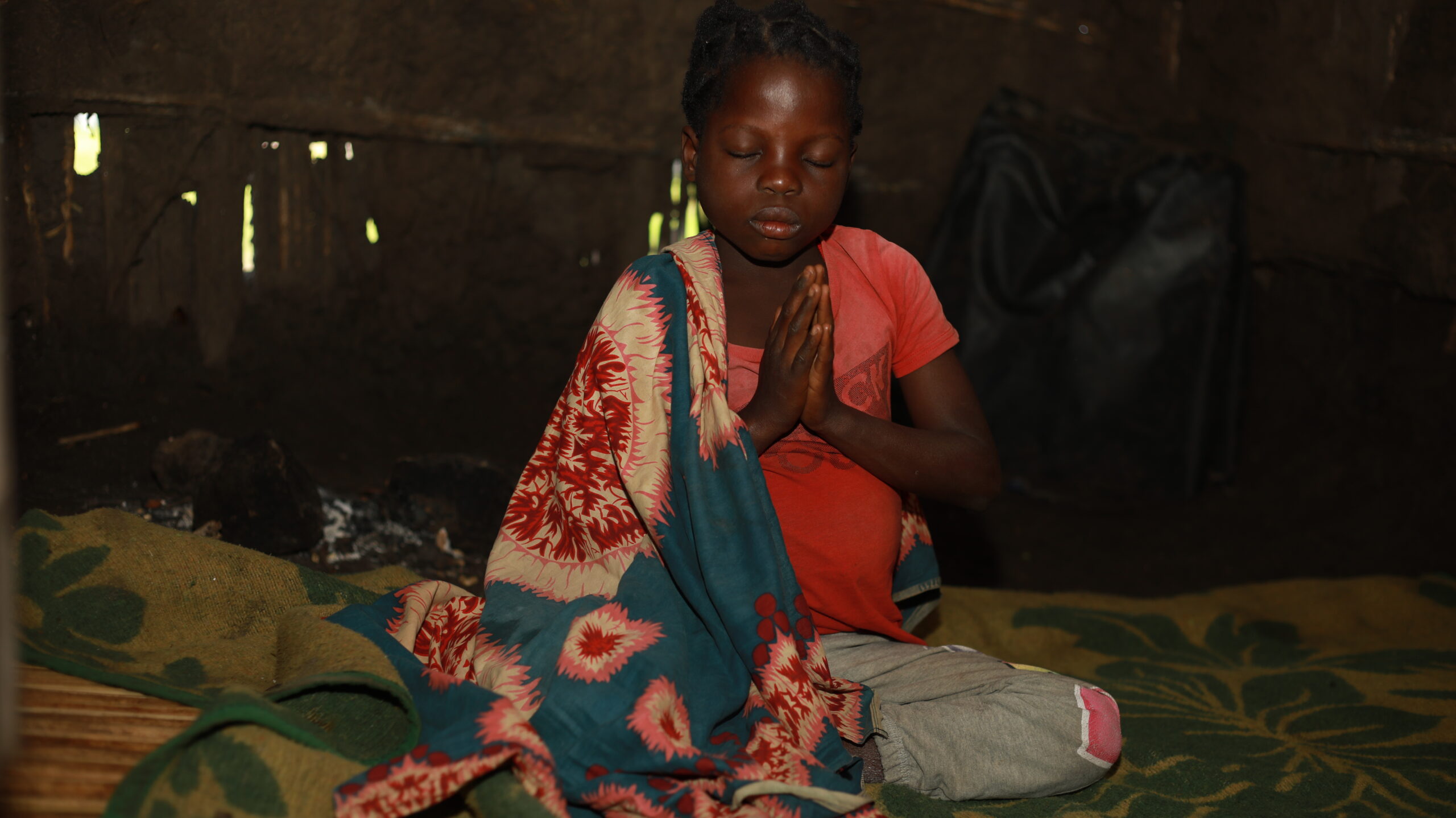 Janete praying at her home